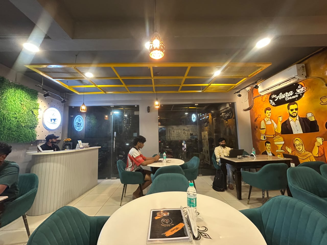 Artistic mural and seating inside The Aura Corner